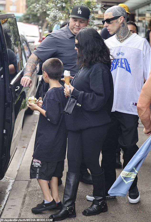 While Travis traveled to Perth, Adelaide and Melbourne with bandmates Tom DeLonge and Mark Hoppus, Kourtney remained in Sydney with her children.