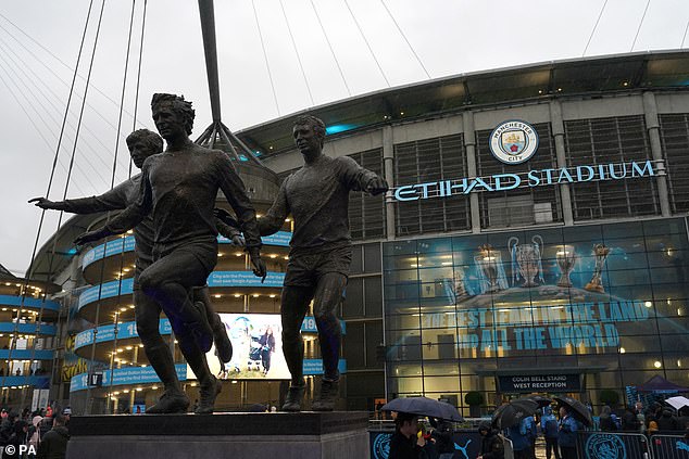 Fans waited in the pouring rain to see the Manchester City players arrive before kick-off.