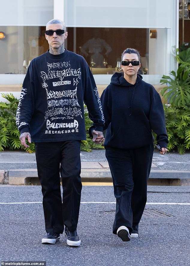 Kardashian wore a dark hoodie with baggy sweatpants, while Barker donned a Balenciaga sweatshirt and dark pants.