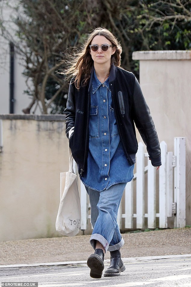 She looked effortlessly chic for the outing in double denim, pairing a long short with cropped mom jeans and ankle boots.