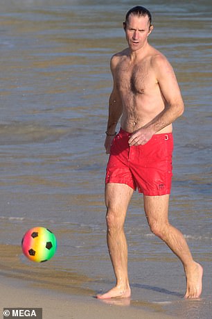 James showed that he has some sporting prowess by kicking a ball on the beach