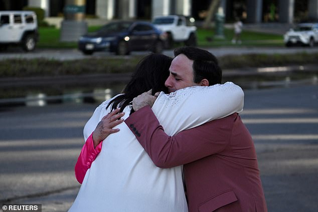 Carlos González, a worship singer, hugs a fellow church member after the shooting.