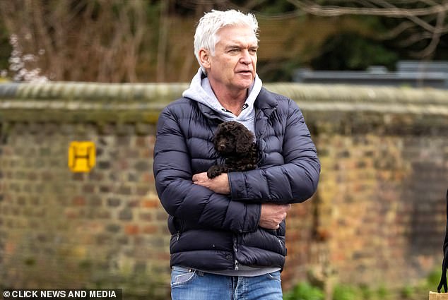 Phillip Schofield was seen for the first time since it emerged he paid the broker he was in a relationship with a six-figure sum and asked him to sign a confidentiality agreement. He was seen walking around west London with a new puppy.
