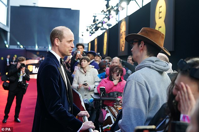 Selfies: William appeared to lean in to pose for selfies with fans as he arrived at the event.