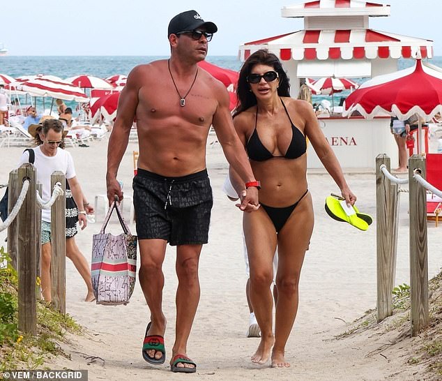 Teresa showed off her curves in a tiny black bikini, made up of a triangular top and string panties. The Real Housewives of New Jersey star's long, dark hair was styled in loose waves.