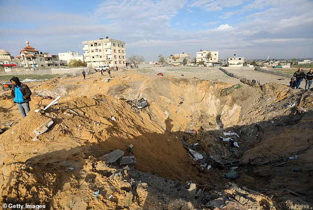 People in Gaza inspect damage to their homes following an Israeli airstrike on Sunday.