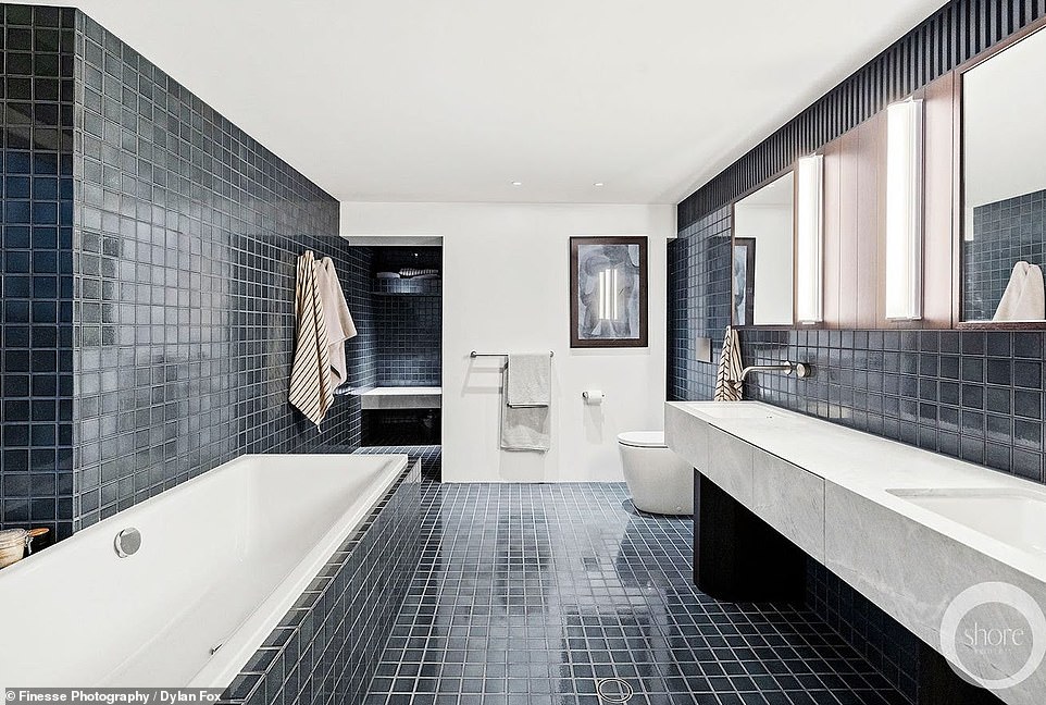 The bathroom is also exquisite with black tiles.