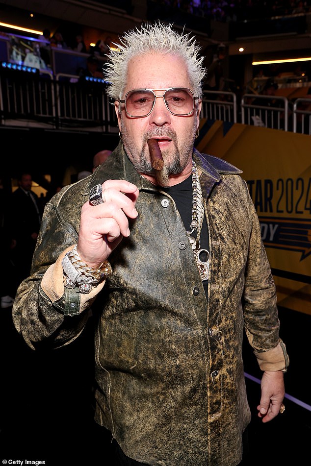 Guy Fieri posed at the game with a cigarette in his mouth and some flashy jewelry
