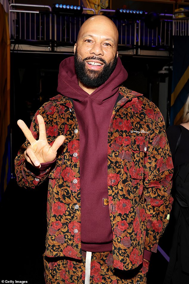 Rapper Common wore a floral jacket and maroon hoodie as he posed for the camera.