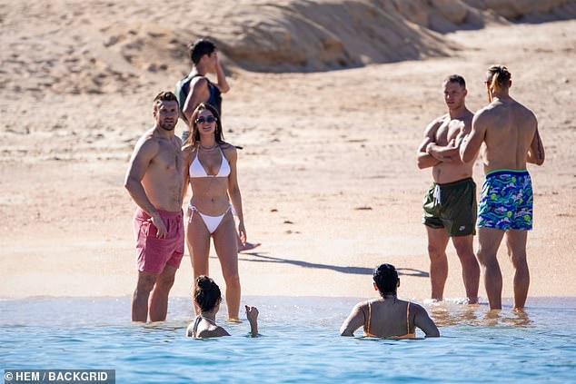 San Francisco players and their partners enjoy a dip in the sea after the Super Bowl