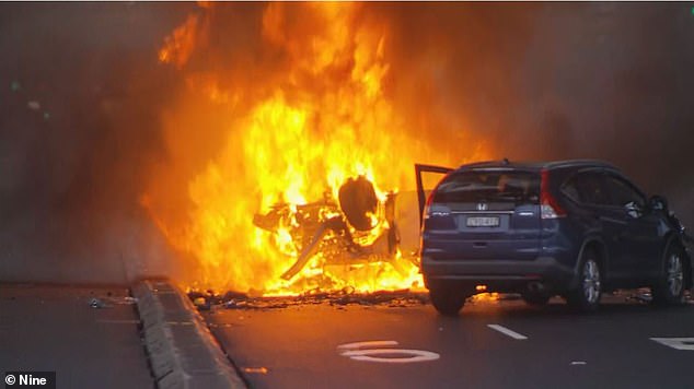The stolen vehicle burst into flames (pictured) after the SUV overturned after hitting an oncoming van.