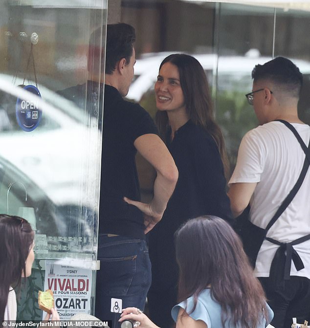 Jodi couldn't wipe the smile off her face as she stood close to her handsome partner, who sported a smart-casual look in a black polo and jeans.
