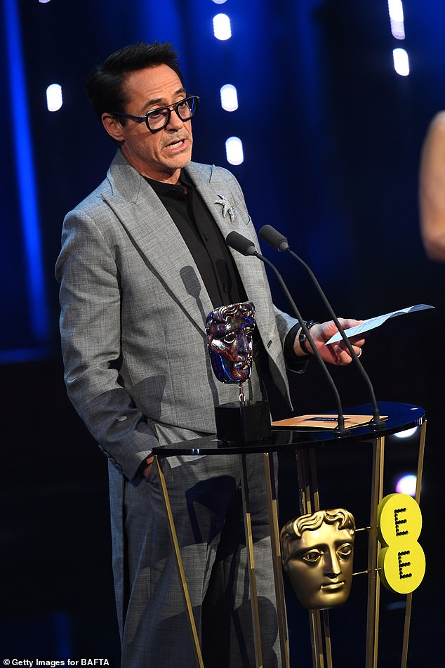 Robert Downey Jr. accepts the award for best supporting actor for Oppenheimer