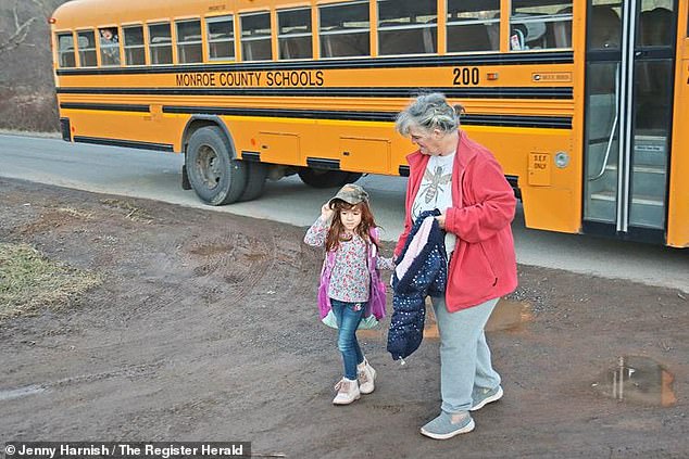Kolbie's grandmother, Tammy Hale, meets her granddaughter at the bus stop. Kolbie is the last passenger to get off the bus.