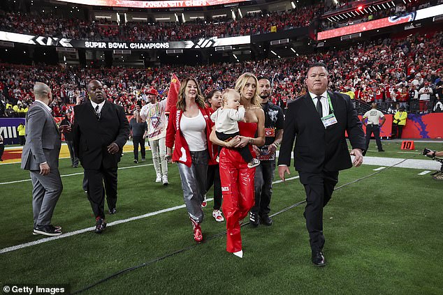 Patrick Jr.'s mother, Randi (left) and his wife Brittany, walk onto the field after Super Bowl LVIII.