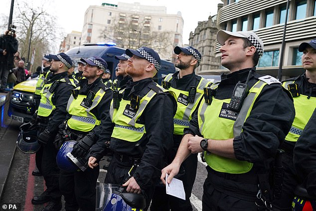 Police officers stand shoulder to shoulder as the march takes place.  Some 1,500 officers had been brought in from around the country to maintain order.