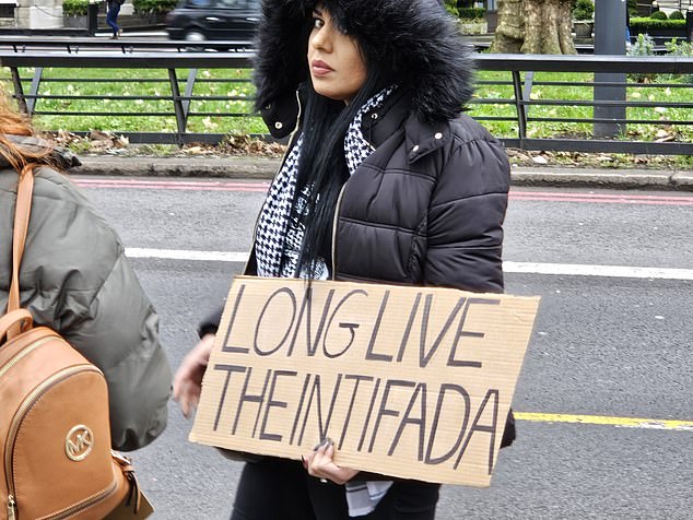 A woman was arrested after being seen holding a cardboard sign that said 
