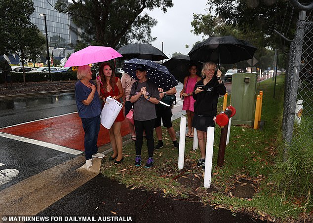 Swift's plane was delayed half an hour when the pop star arrived in Sydney on Monday (pictured: Eager fans wait to see her at Sydney Airport)