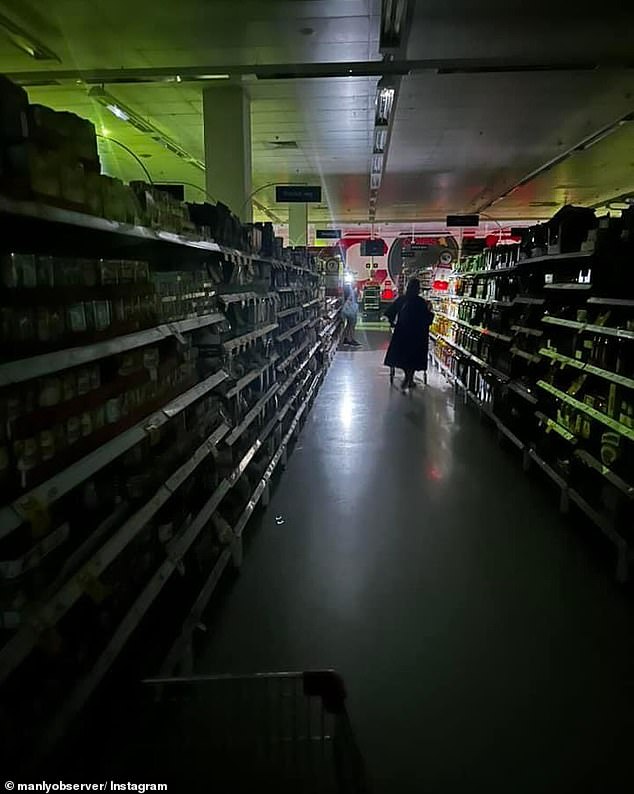 A Coles in Balgowlah is seen in complete darkness after a major storm hit the town on Monday.