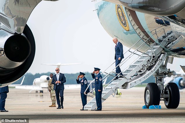 Two Air Force agents and a Secret Service agent are seen waiting for Biden at the bottom of the shortest stairs leading to the lower entrance to Air Force One.