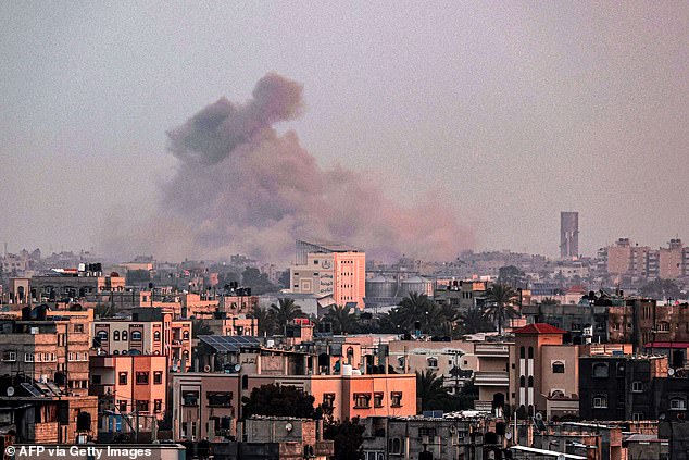 A photograph taken from Rafah shows smoke rising over Khan Yunis in the southern Gaza Strip during Monday's Israeli bombardment.