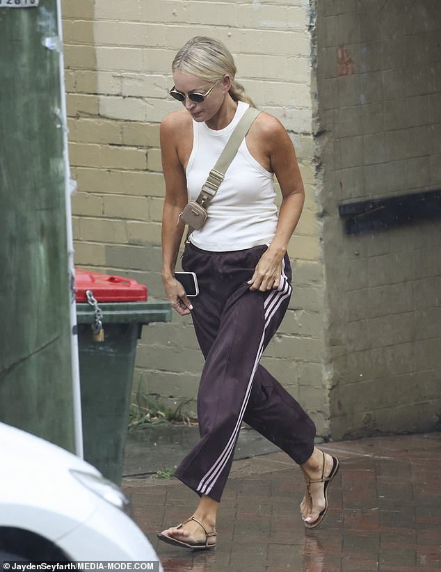 The radio queen, 49, wore a casual look for the date, opting to wear comfortable brown Adidas sweatpants and open-toed shoes.