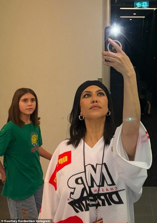 Kourtney showed off her laid-back style in a casual oversized sports T-shirt, which she wore as a dress, while taking a selfie with her daughter Penelope.