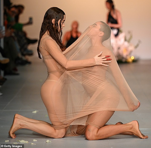 The interpretive scene seemed to increase in intensity when a model stretched the fabric of her dress.