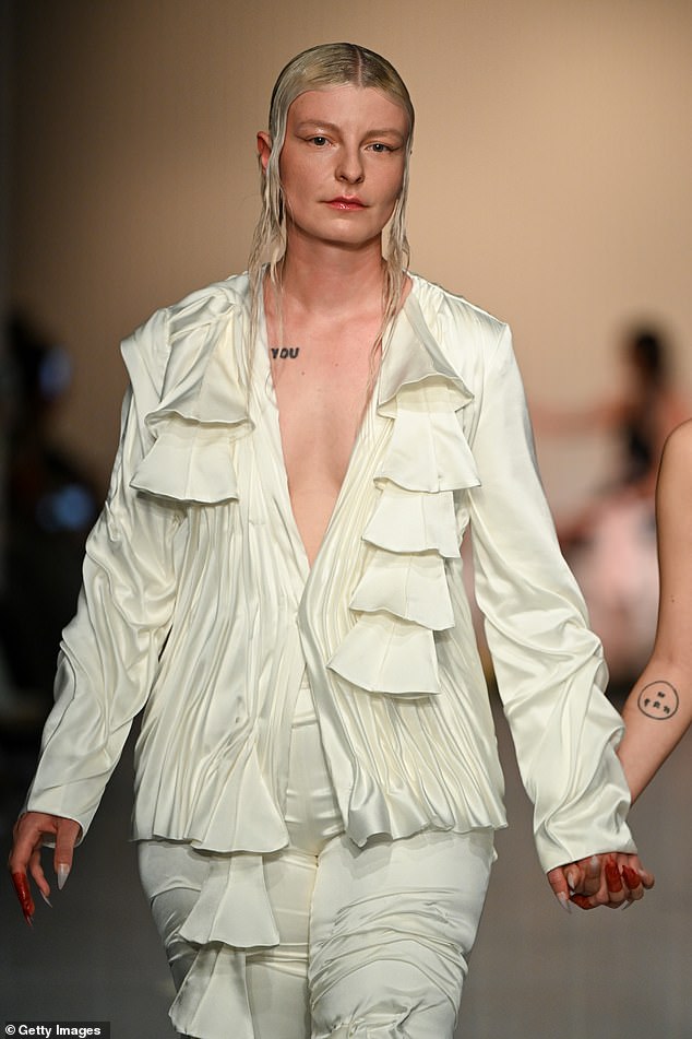 A cream pirate blouse, daringly low-cut and with ruffle details, was the centerpiece of another model's daring look.