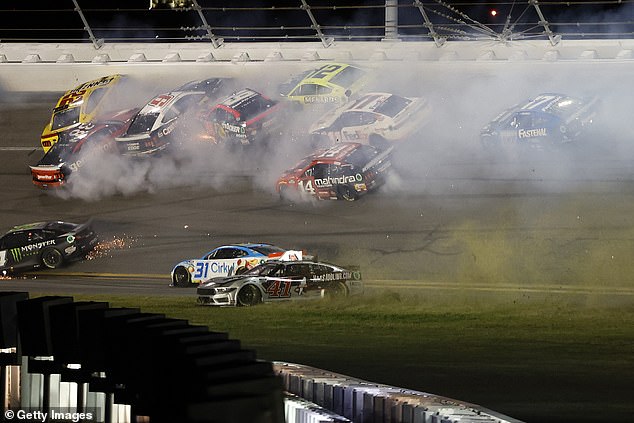 Sparks and smoke come out of the cars after the accident that occurred less than 10 laps from the end