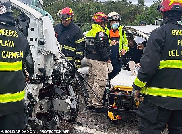 One of the two surviving Argentine tourists injured in the crash lies on a stretcher after he was pulled from the wreckage of the van moments after it crashed into a parked van.