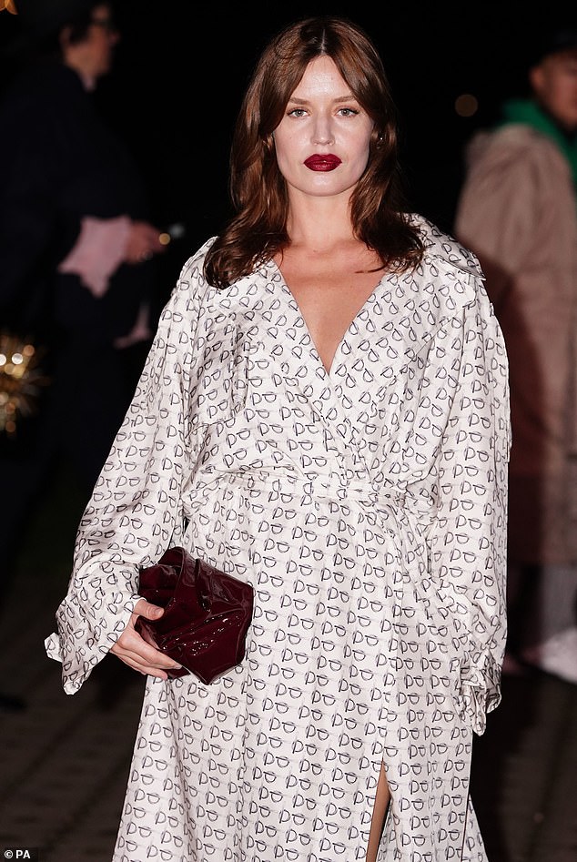 Mick Jagger's daughter increased her height in pointed black heels and carried a small clutch while adding a pop of color with dark red lipstick.