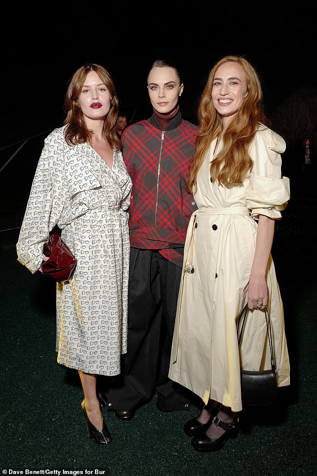 The sisters were joined by Cara Delevingne who opted for a red plaid sweater
