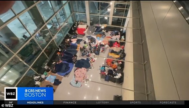 Immigrants are seen sleeping rough at Boston's Logan Airport in the international terminal.