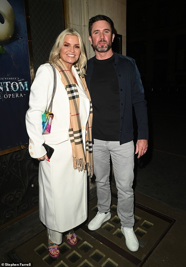 She added inches to her gorgeous figure as she paired her look with a pair of rainbow-colored Kurt Geiger wedges and a matching clutch while out and about with her fiancé Ryan Mahoney (pictured).