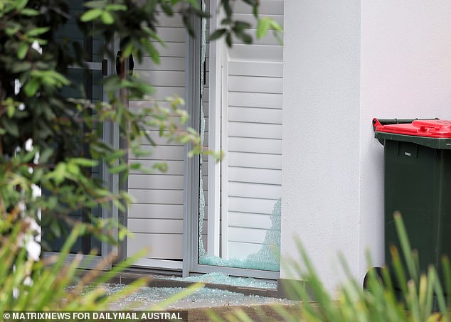The front window was smashed at the Baulkham Hills home where the dead man's body was found.