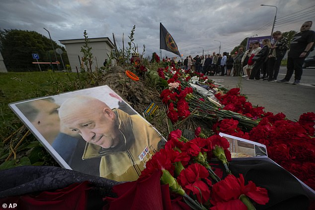 A portrait of the owner of the private military company Wagner Group, Yevgeny Prigozhin, stands on an informal monument next to the former 