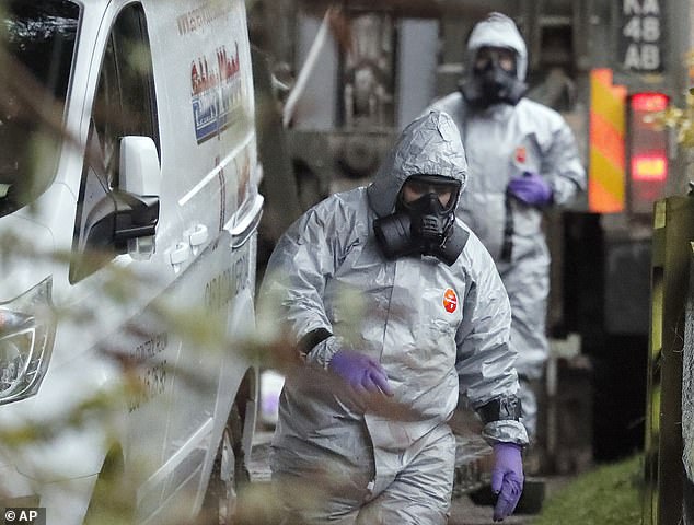 Staff in protective gear work in a van in Winterslow, England, on March 12, 2018, as investigations continue into the nerve agent poisoning of former Russian intelligence officer Sergei Skripal and his daughter Yulia.