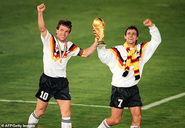 Pierre Littbarski and Lothar Matthaus parade with the trophy after West Germany's victory in 1990