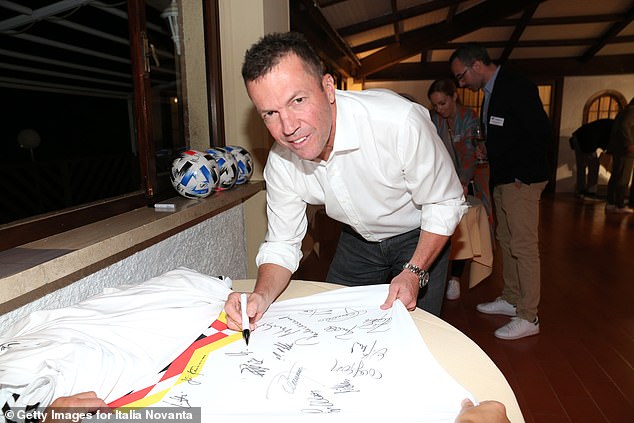 Lothar Matthaus signs a 1990 Germany shirt at a reunion event in Italy in October 2020