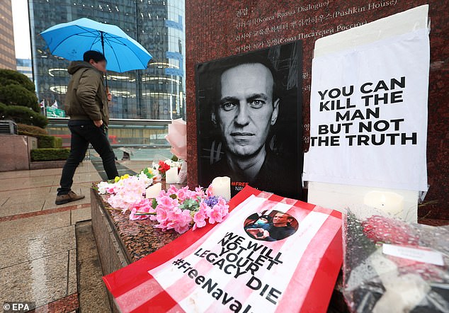 Tributes to the late Russian opposition leader Alexei Navalny in front of a monument with a work by the late Russian poet Alexander Pushkin, in Seoul