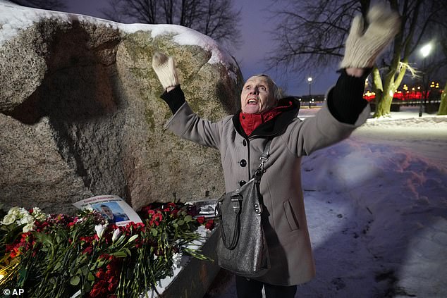 People gathered to lay flowers in tribute to Alexei Navalny at the monument, a large rock on the Solovetsky Islands, where the first camp of the Gulag political prison system was established, in St. Petersburg.