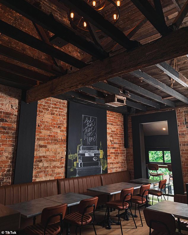 Upon entering, visitors are greeted with a space that blends contemporary and vintage, with exposed dark wood beams on the ceiling, low-lit chandeliers, and exposed brick walls.