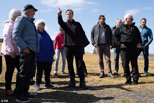 Cameron (centre) meets local people at St Charles Cemetery in the Falkland Islands, during his high-profile visit.