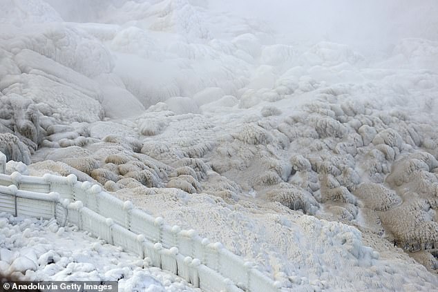 Thick layers of ice and snow around Niagara Falls. The famous waterfall is one of the most visited places in the world.