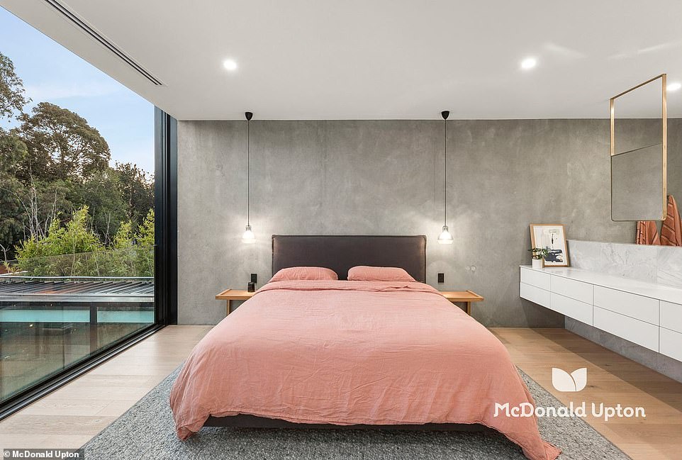 Upstairs is the master bedroom with a Juliette balcony overlooking the gardens below and an open bathroom with elegant brass fixtures, a freestanding bathtub and floating mirrors above a marble double vanity.