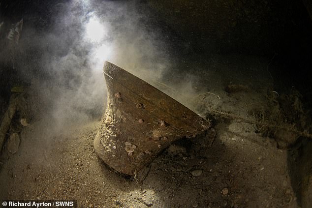 The huge ship's bell sat atop a pile of sand and wreckage of the USS Jacob Jones since 1917