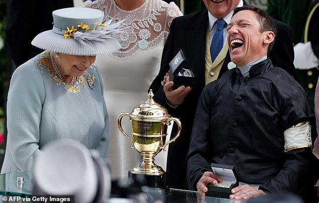 Queen Elizabeth makes Italian jockey Frankie Dettori (right) laugh during the presentation after winning the Gold Cup at Royal Ascot in 2019.