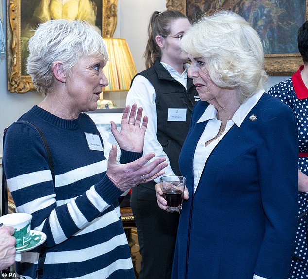 Camilla, who has been keeping busy following King Charles III's cancer diagnosis, also met Detection Dogs ambassador Gill Wright (left).