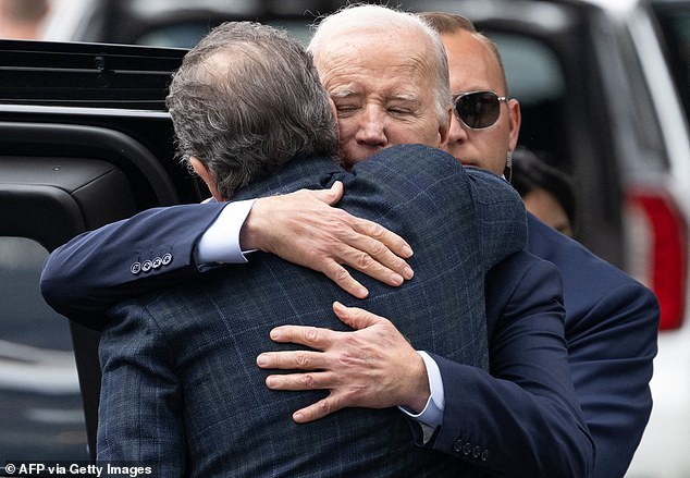 US President Joe Biden hugs his son Hunter Biden as they leave The Ivy restaurant in Los Angeles, California, on February 4, 2024.